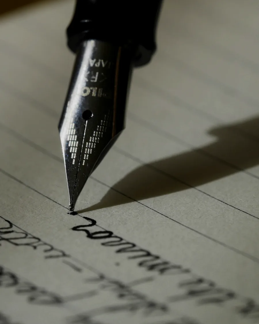 A fountain pen resting on a signed document in low, raking light